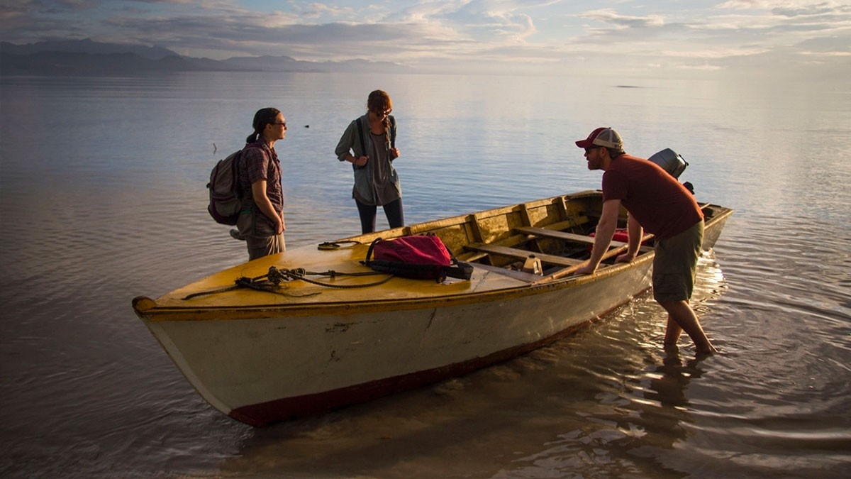 Students helping fishermen in a foreign country