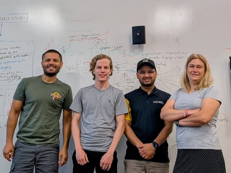 NKU School of Computing and Analytics research team smile for a picture together.