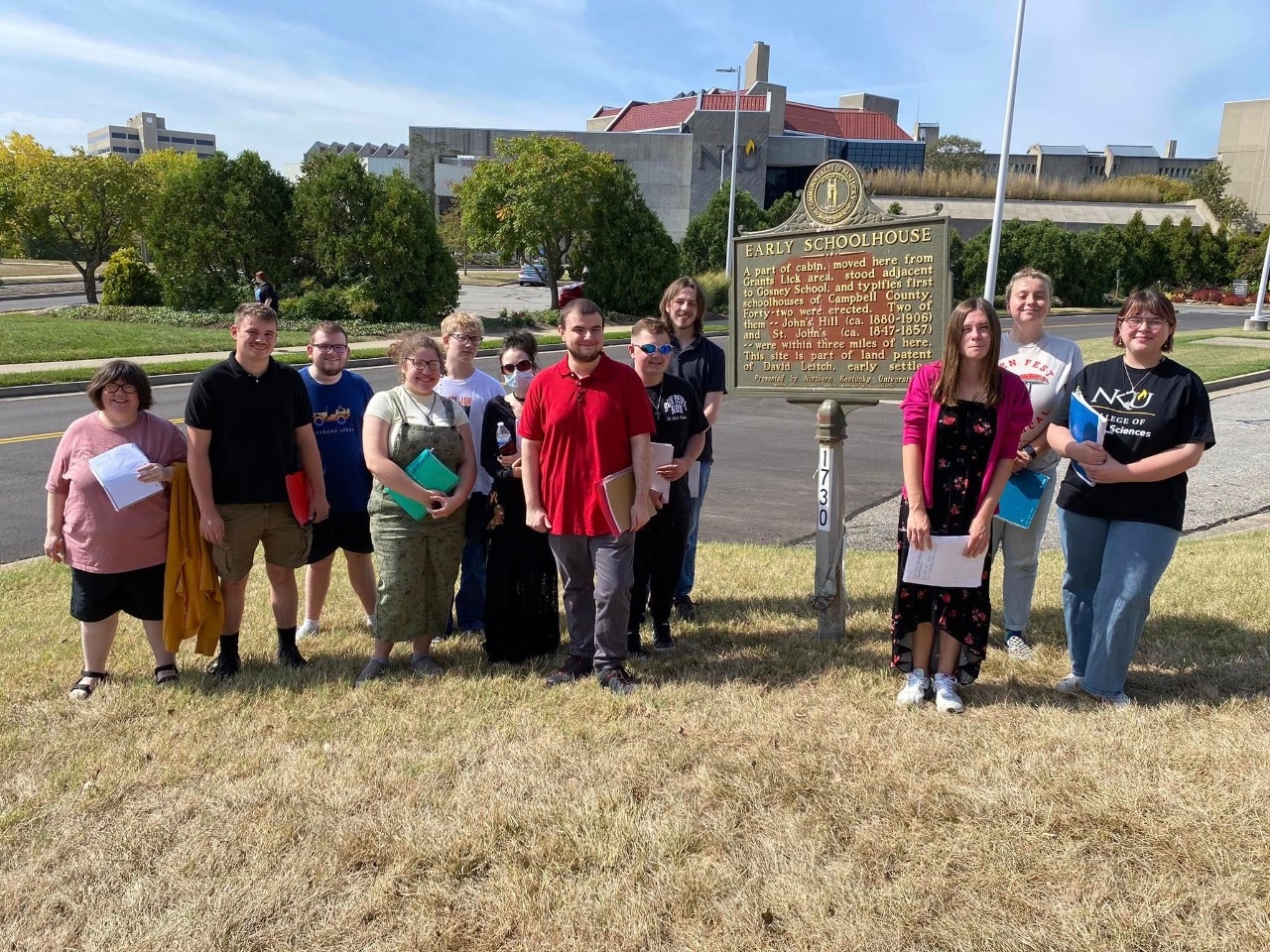 Students at historic cabin on campus