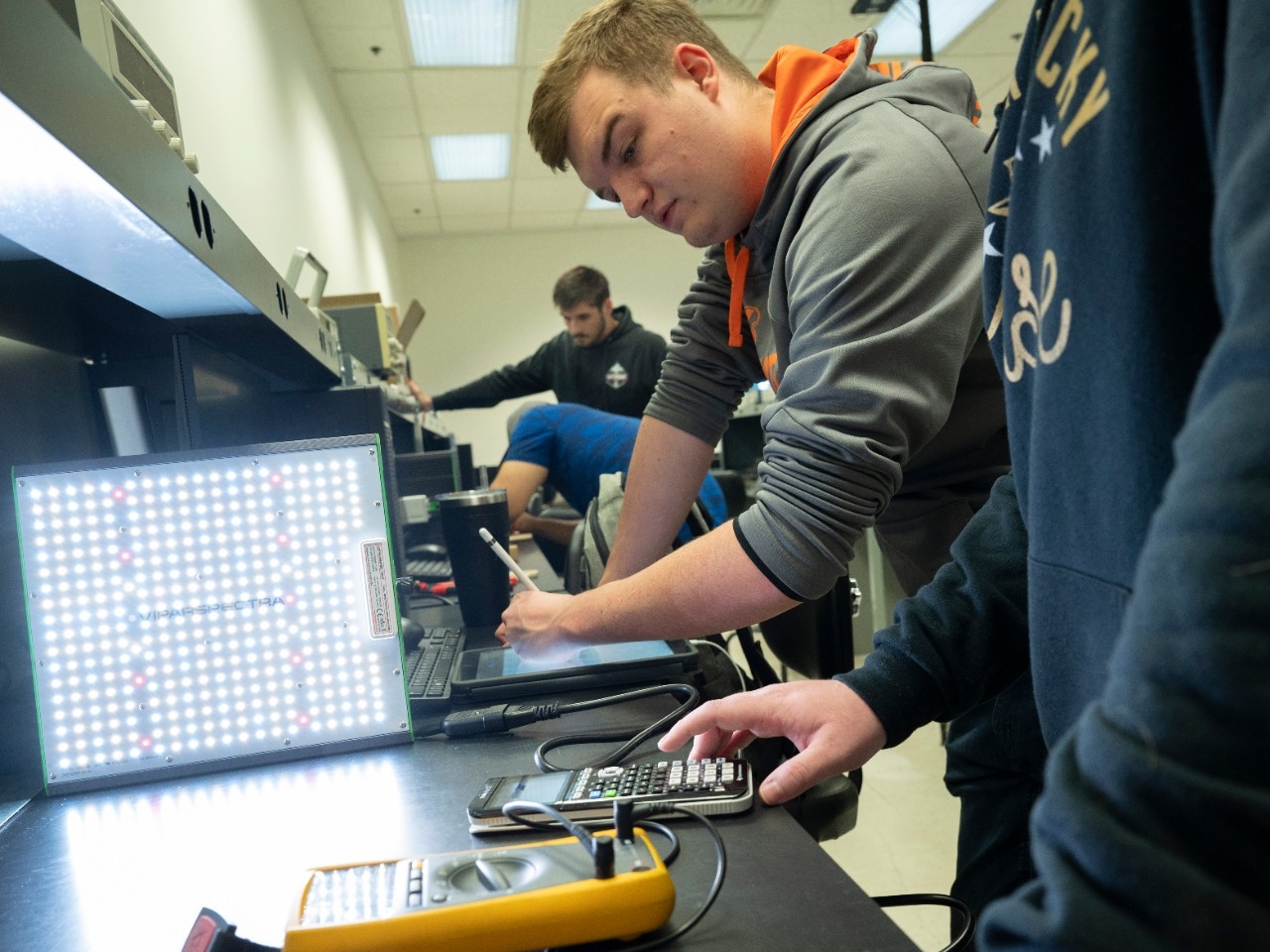 Engineering students practicing with electronics in a laboratory