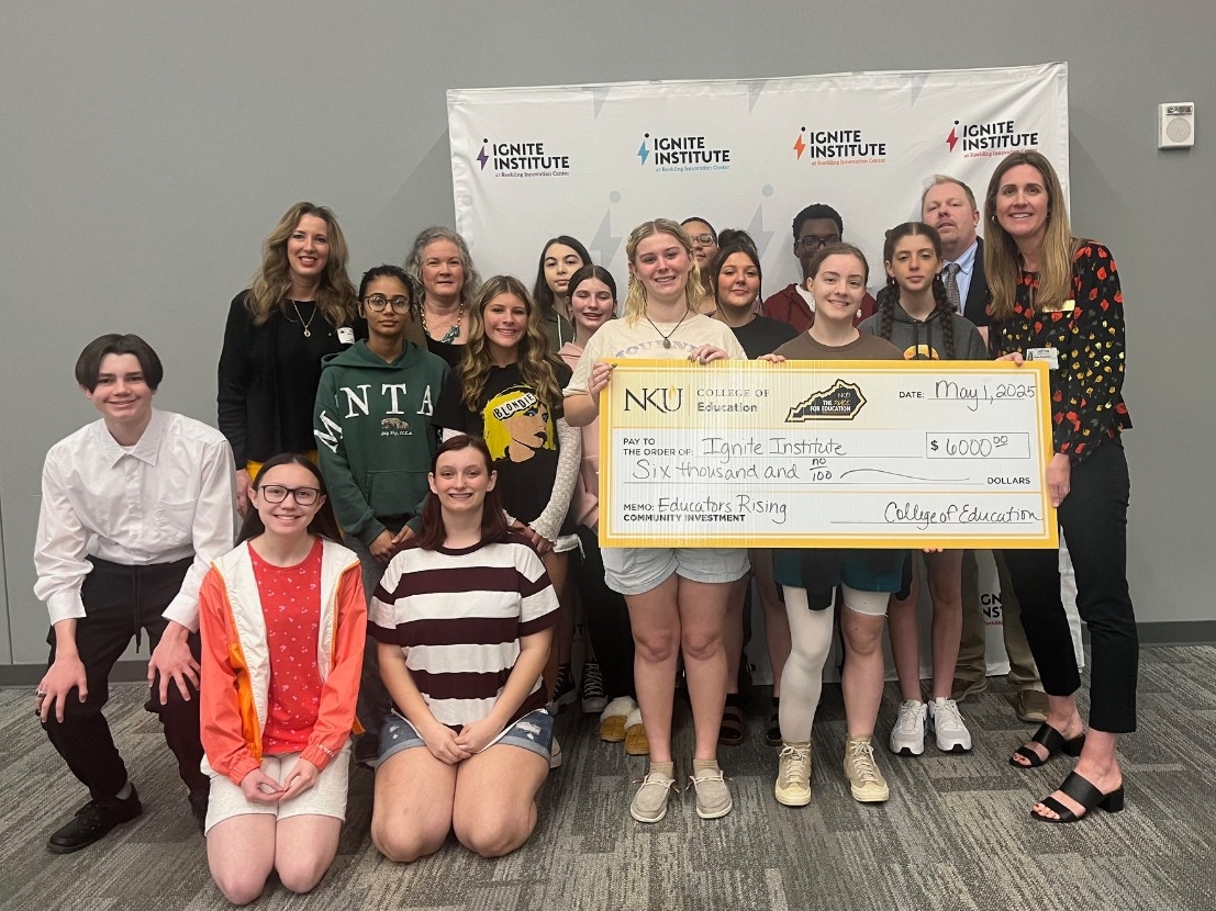 The College of Education presents students at the Ignite Institute with a check to fund their travels to the Educators Rising National Conference.